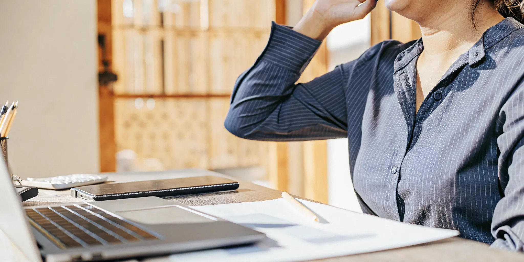 do-you-need-collateral-for-a-business-loan-a-complete-guide-for-small-business-owners-954888 Small business owner reviewing financial documents on a laptop in a modern office