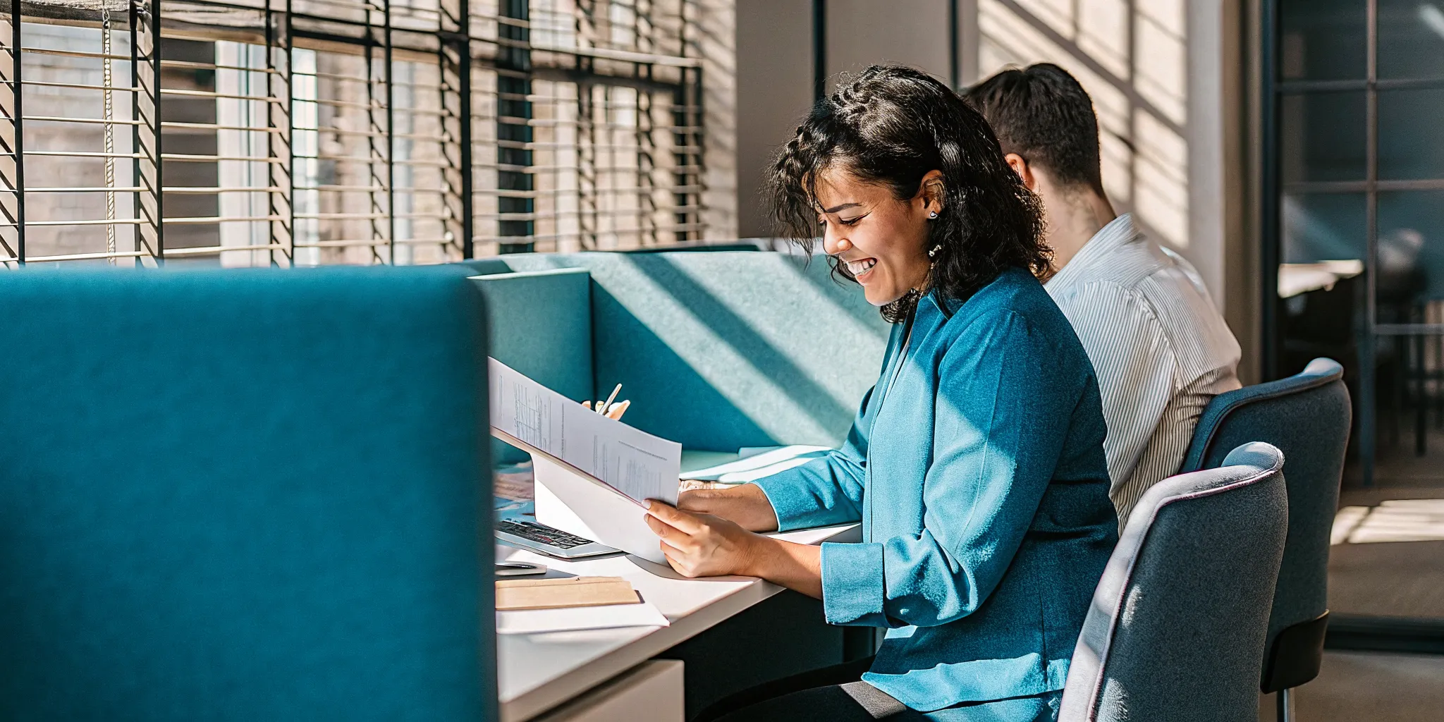 revenue-based-financing-pros-and-cons-for-your-business-716611 Small business owner reviewing financing documents at their desk