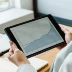 Small business owner reviewing a flexible revenue-based payment schedule on a tablet