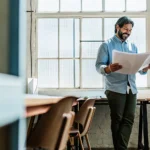 Small business owner reviewing financing options with a financing specialist in a modern office