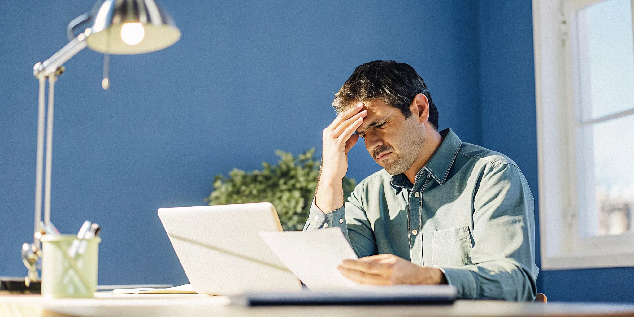 Small business owner reviewing a rejected loan application
