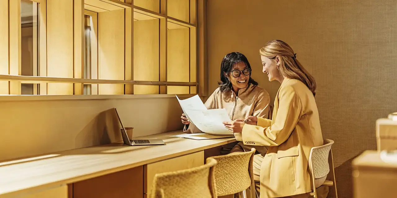 business-loan-requirements-what-lenders-look-for-569427 Small business owner reviewing business loan requirements with a financing specialist
