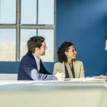 Small business owners meeting with a financing specialist in a bright office