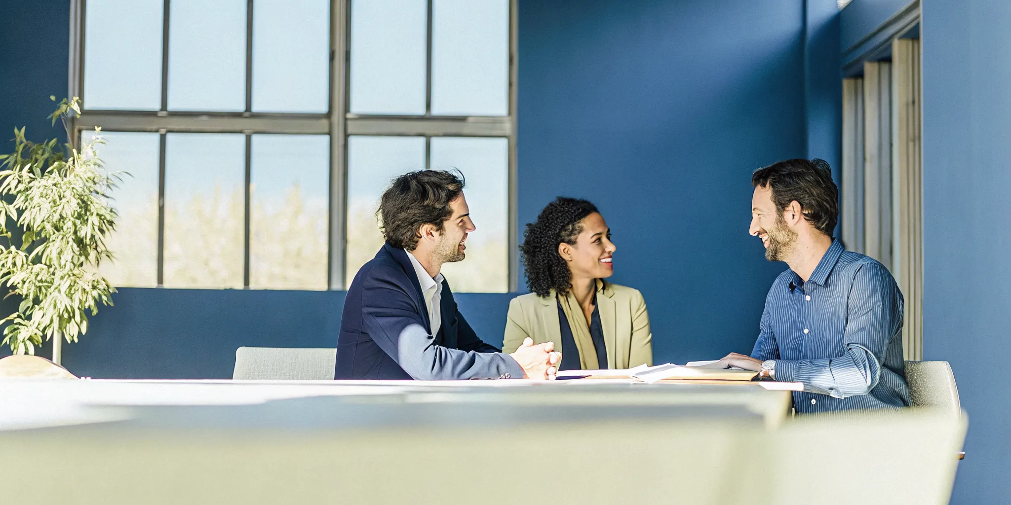 how-alternative-business-lending-works-what-to-expect-678182 Small business owners meeting with a financing specialist in a bright office